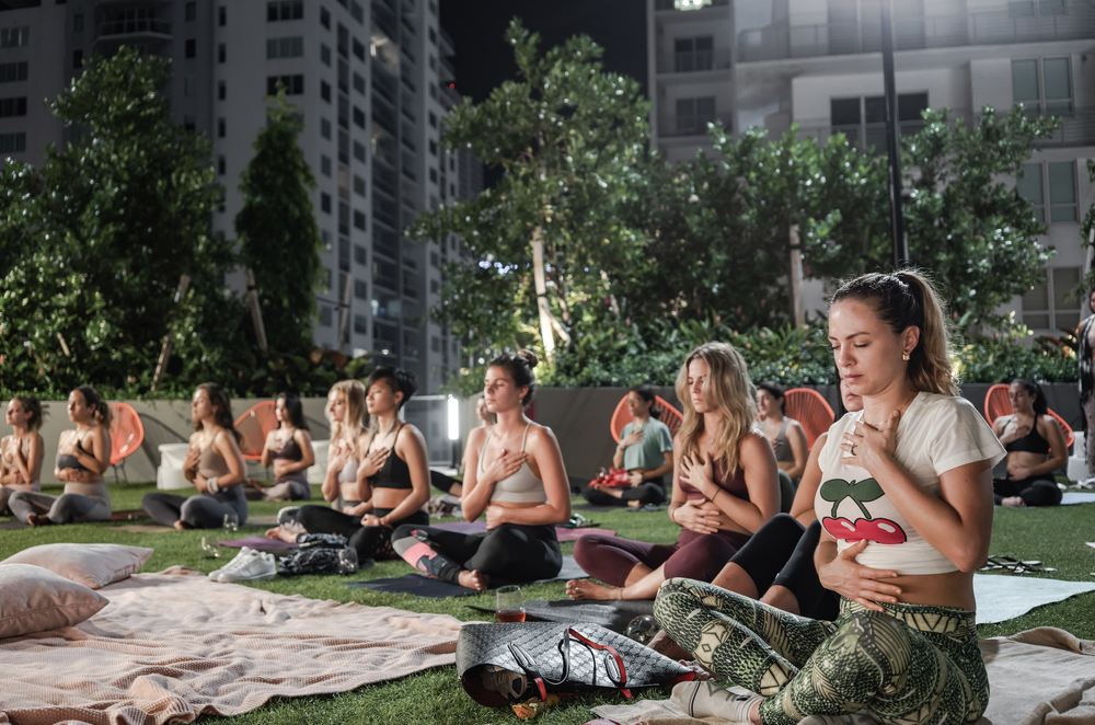 A community ritual gathering inside a softly lit architectural space — Emotional Architecture in practice.